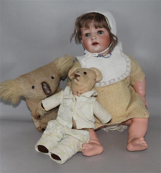 A doll and two soft toys